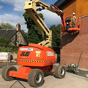Diesel Cherry Picker being used on building Cladding